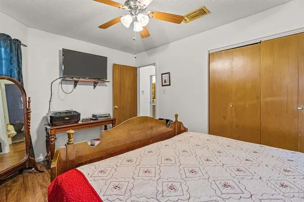 a bedroom with a bed and dresser