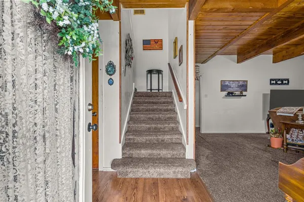 a very nice looking room with a large window appliances and cabinets