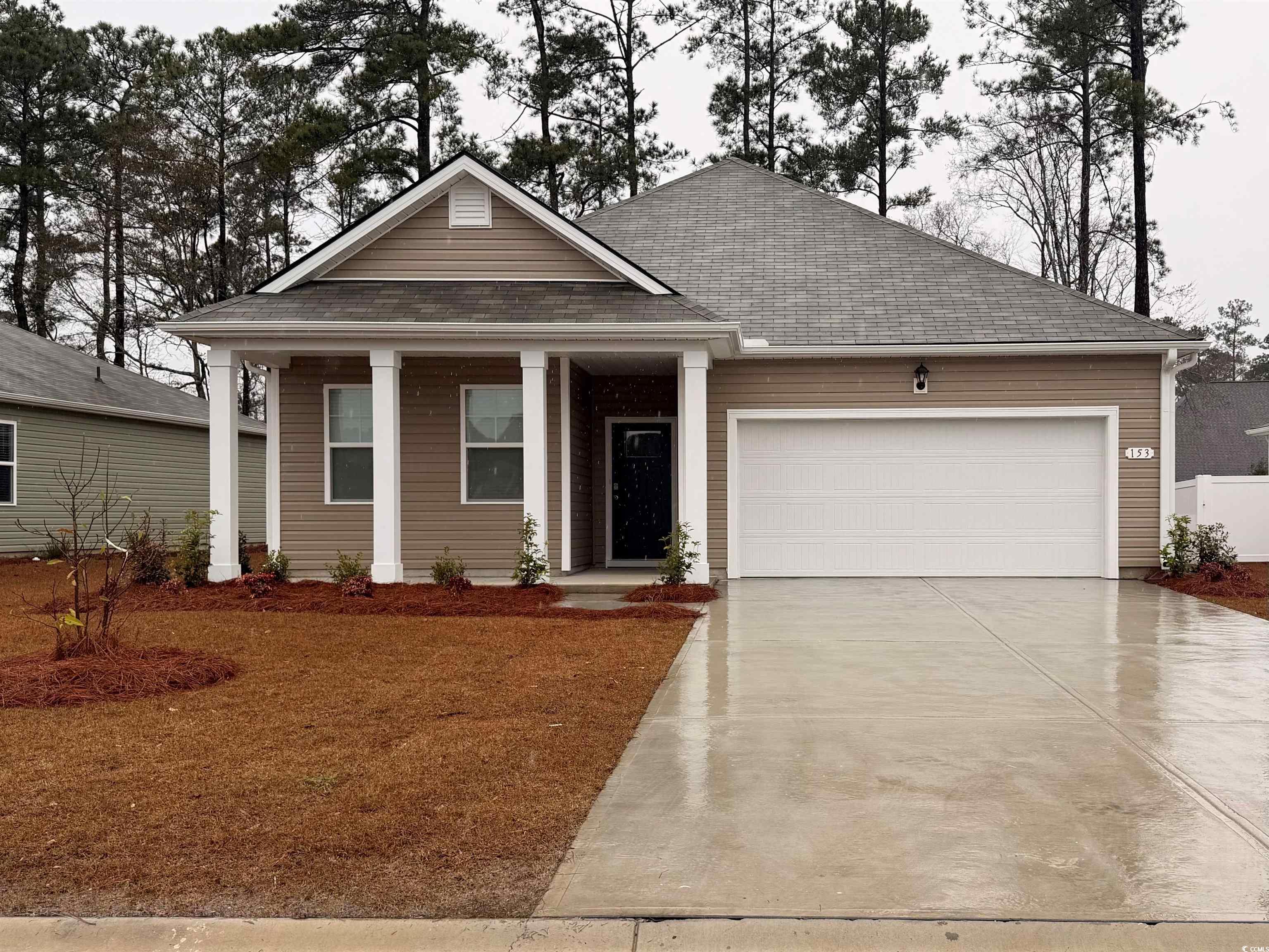 153 Dagger Court Myrtle Beach, SC 29588 - Photo 1 of 25 View of front of property with a shingled roof, a front lawn, a garage, concrete driveway, and covered porch