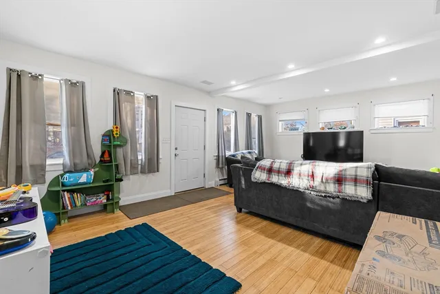 a room with lots of furniture and wooden floor