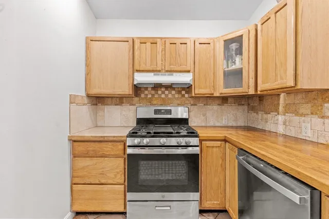 a kitchen with a sink cabinets and window
