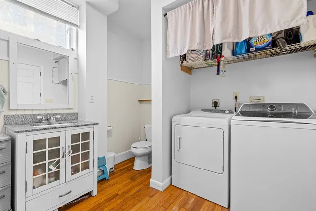 a view of a room with wooden floor and cabinets