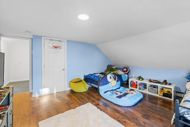 a bedroom with furniture and a book shelf