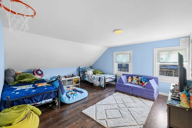 a bedroom with furniture and a wooden floor