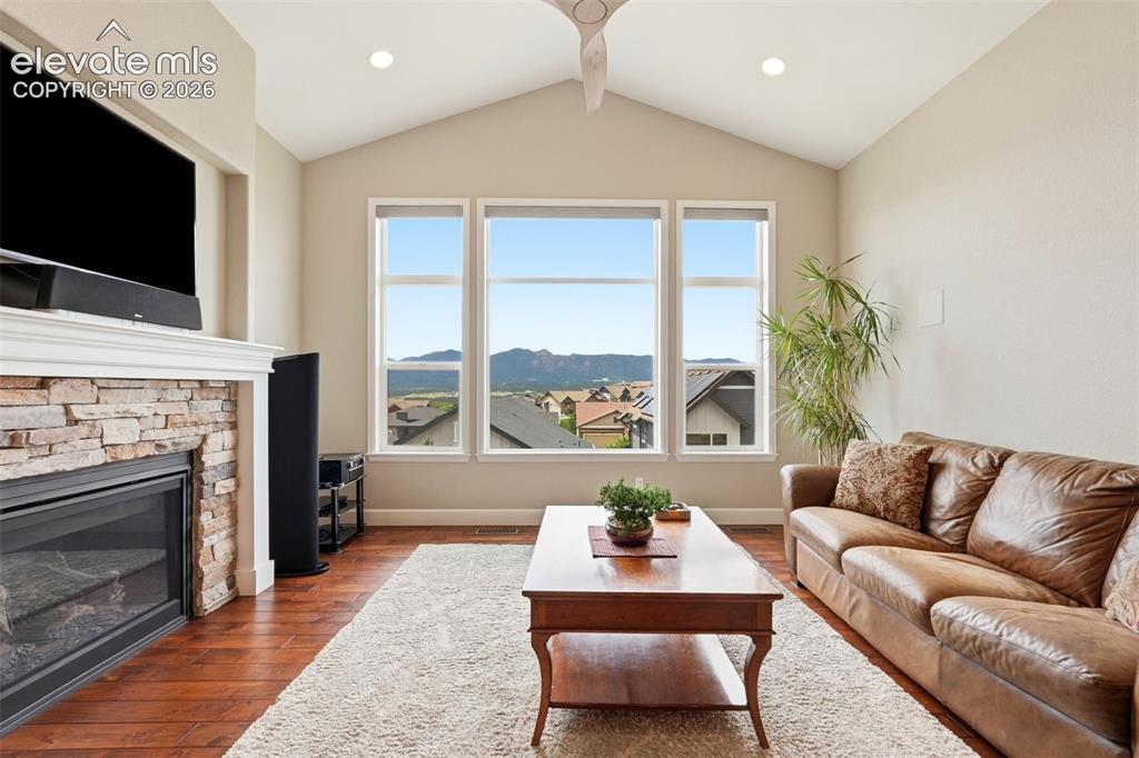 1394 Promontory Bluff View Colorado Springs, CO 80921 - Photo 14 of 47 a living room with furniture fireplace and a flat screen tv