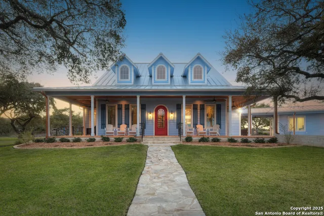 a front view of a house with a garden and patio