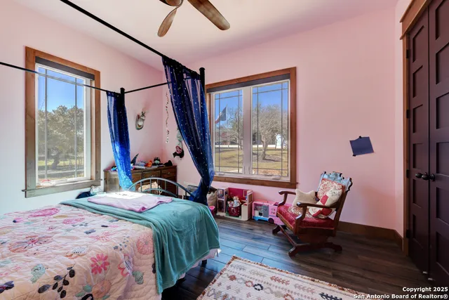 a dining room with furniture and a floor to ceiling window