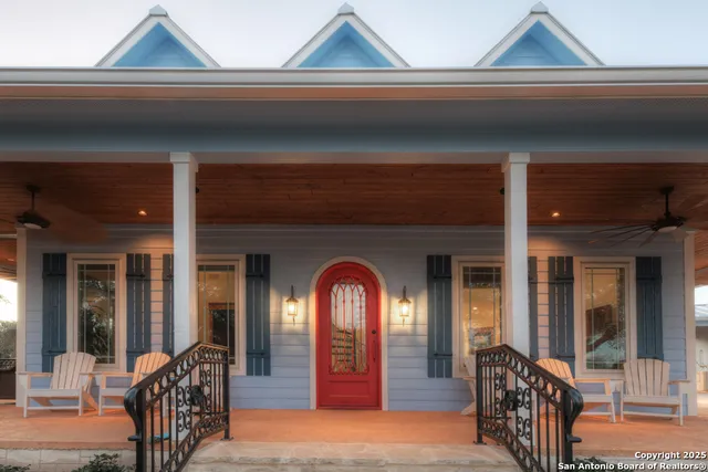 a front view of a house with a yard and trees