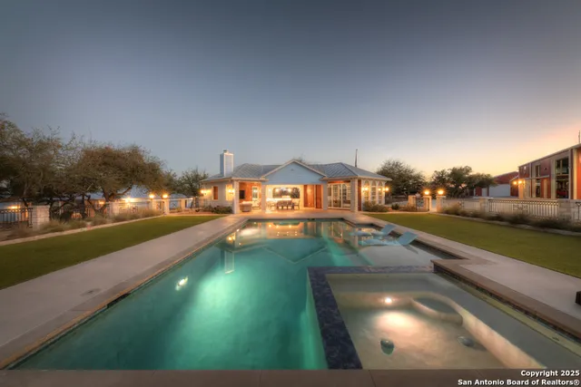 a view of a work space with furniture wooden floor and a ceiling fan