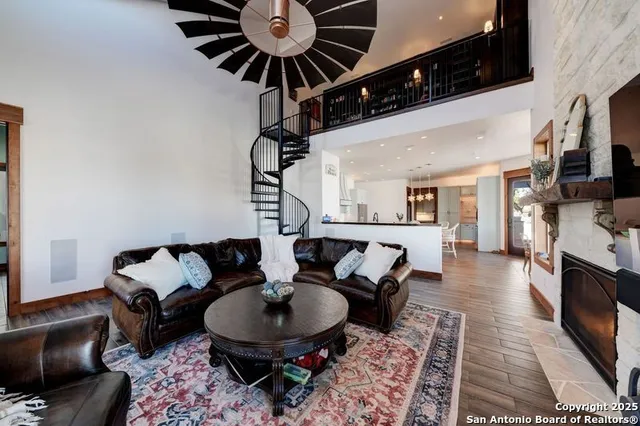 a dining room with stainless steel appliances kitchen island granite countertop a dining table chairs and granite counter tops