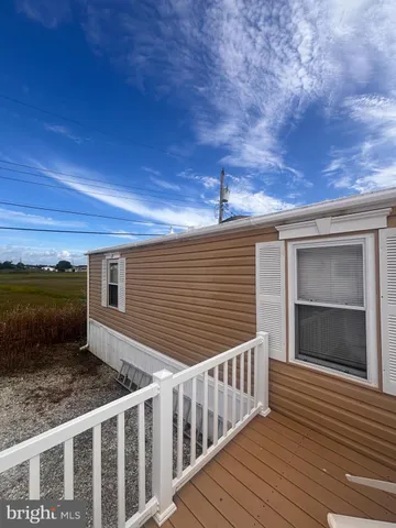 a view of a house with a wooden deck