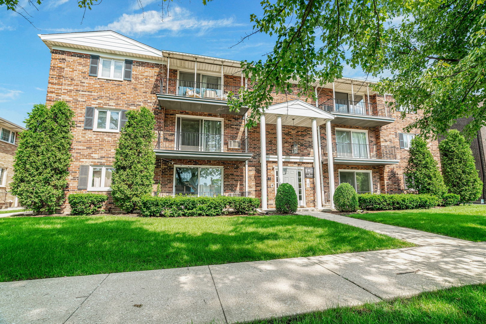 front view of a house next to a yard