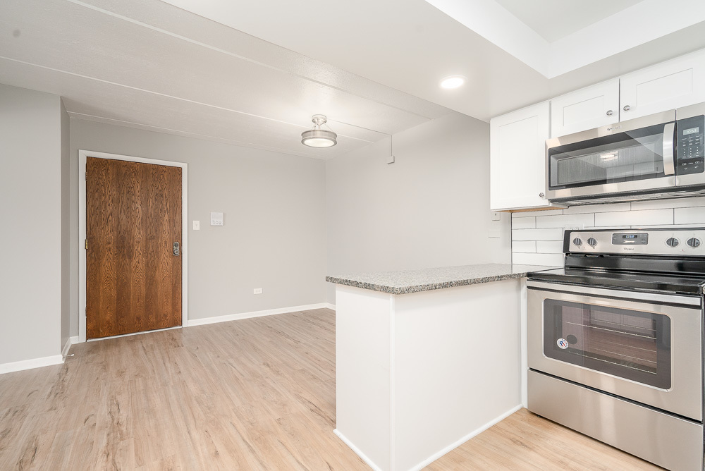 21 South Waiola Avenue, Unit 8 La Grange, IL 60525 - Photo 14 of 18 a kitchen with a stove and a microwave