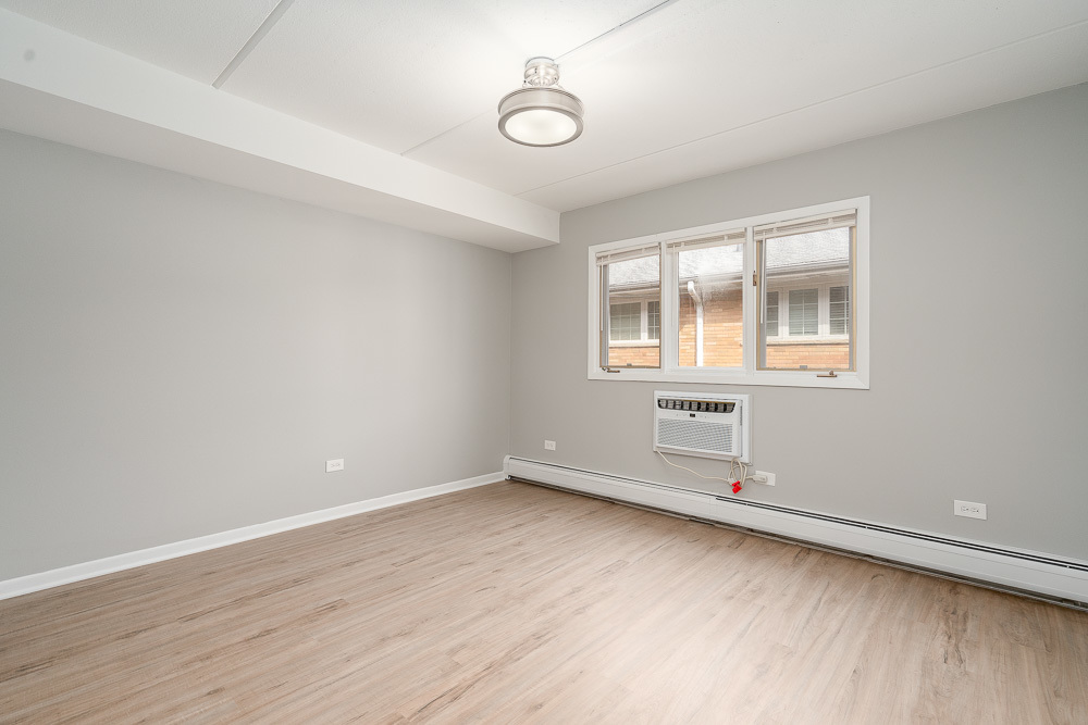 21 South Waiola Avenue, Unit 8 La Grange, IL 60525 - Photo 7 of 18 wooden floor in an empty room with a window
