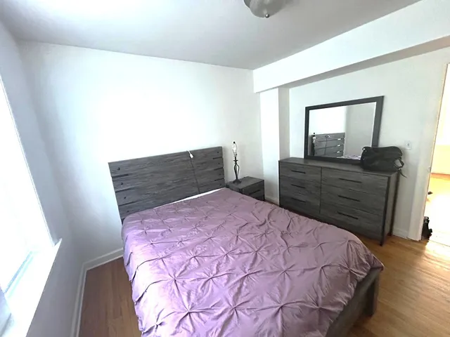 a bedroom with a bed and a dresser