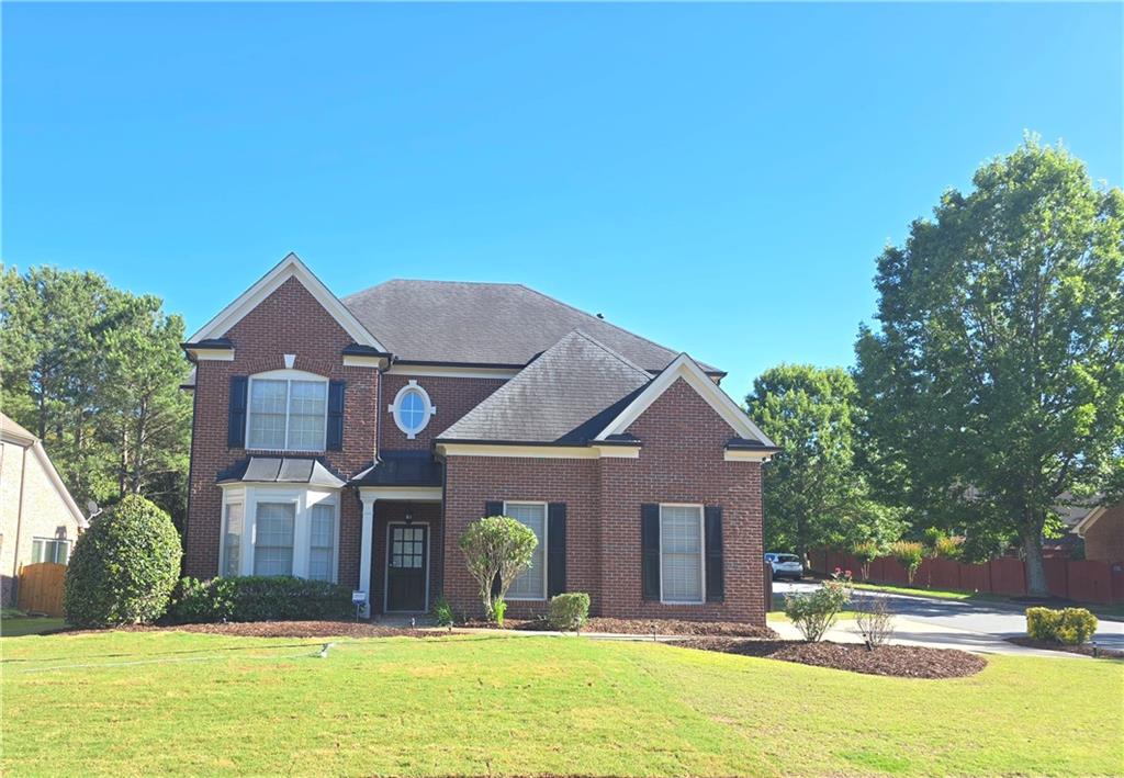 a view of a house with a yard