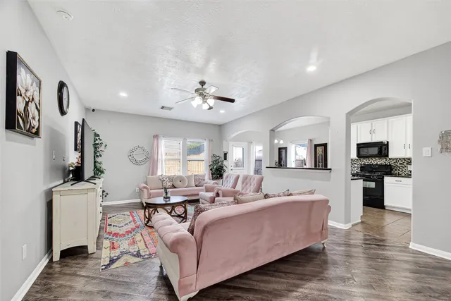 a living room with furniture and wooden floor