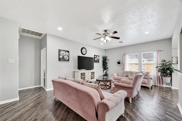 a living room with furniture a rug and a flat screen tv