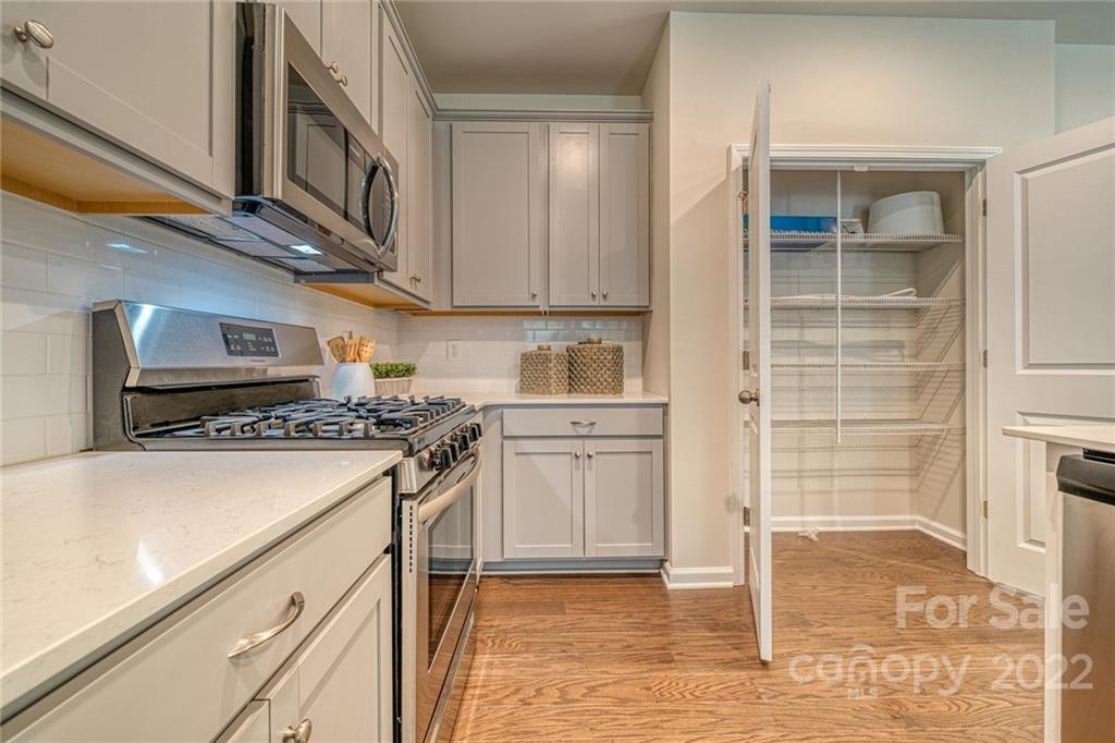 902 Pk Bnd Trail, Unit 72 Tega Cay, SC 29708 - Photo 5 of 13 a kitchen with a stove and a refrigerator