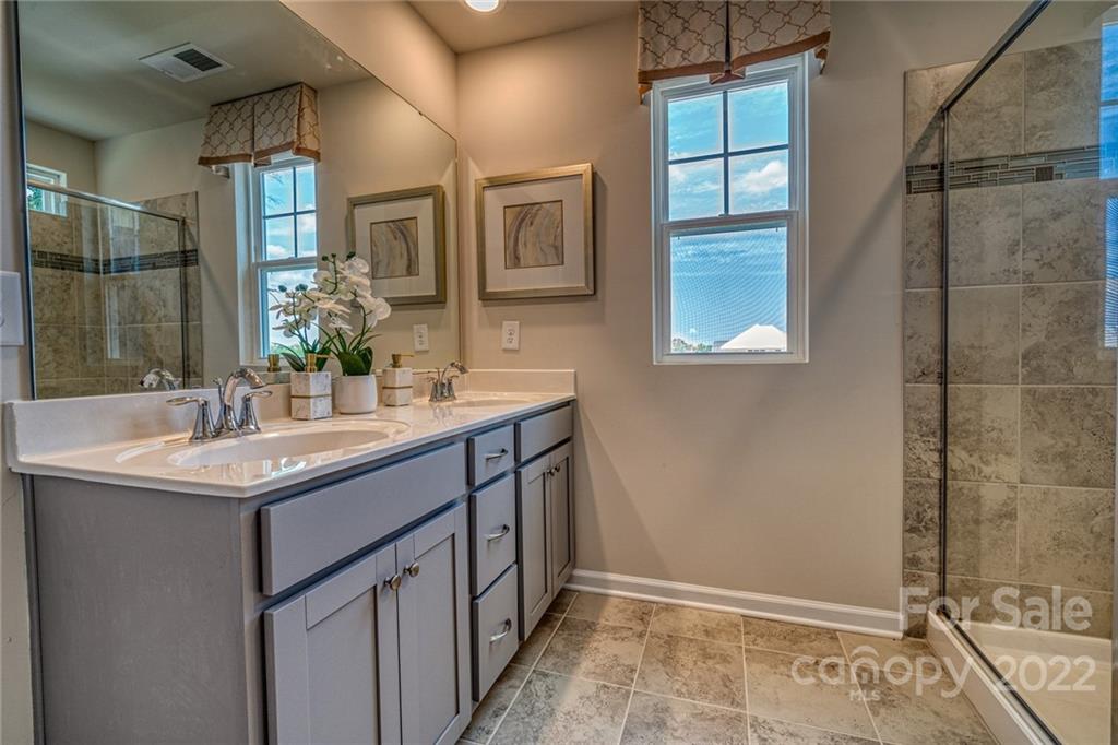 902 Pk Bnd Trail, Unit 72 Tega Cay, SC 29708 - Photo 7 of 13 a bathroom with a granite countertop sink and a mirror