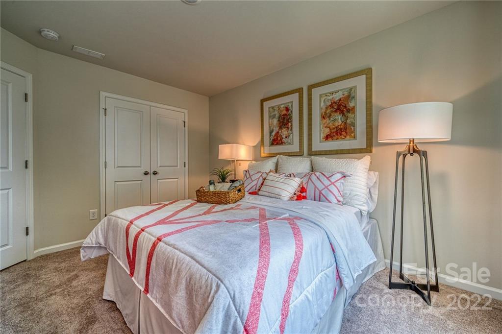 902 Pk Bnd Trail, Unit 72 Tega Cay, SC 29708 - Photo 8 of 13 a bedroom with a bed and a night stand