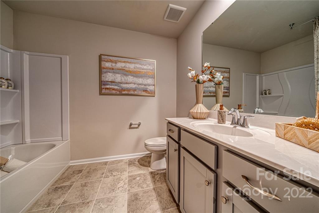 902 Pk Bnd Trail, Unit 72 Tega Cay, SC 29708 - Photo 10 of 13 a bathroom with a double vanity sink mirror and toilet