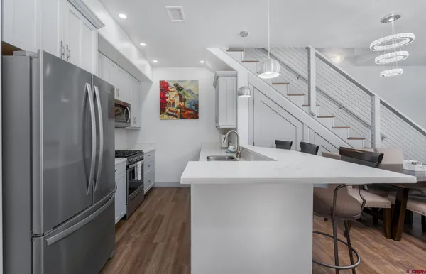 a kitchen with stainless steel appliances a refrigerator and a sink