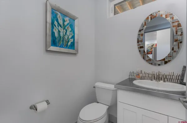 a bathroom with a toilet a sink and mirror