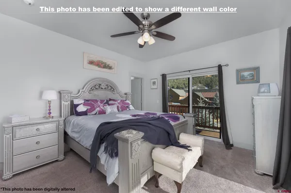 a bedroom with a bed and a large window