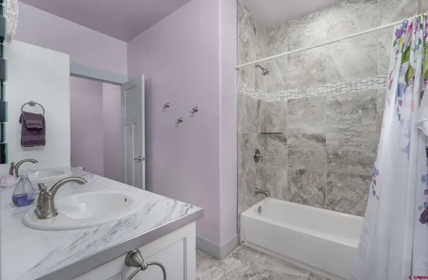 a bathroom with a sink a bathtub and a shower