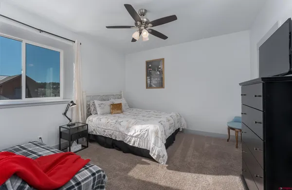 a bedroom with a bed and a tv