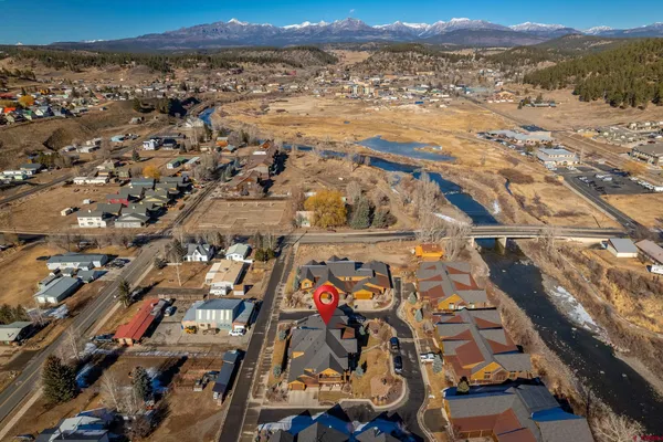an aerial view of residential houses with outdoor space