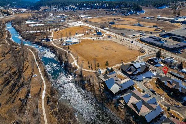 an aerial view of residential houses with outdoor space
