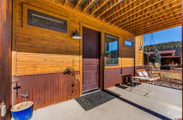 a view of a backyard with a chair and a grill with wooden floor