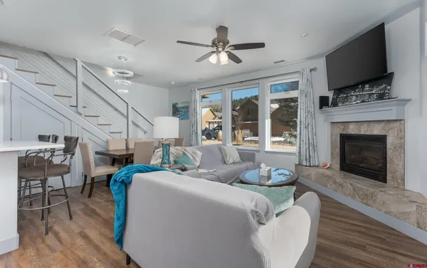 a living room with furniture fireplace and flat screen tv