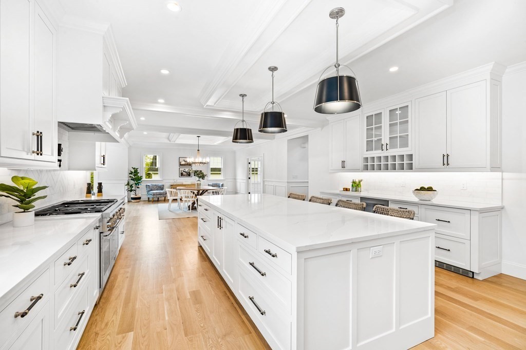 4 Jordan Way Hingham, MA 02043 - Photo 14 of 42 a kitchen with stainless steel appliances a stove a sink a chimney wooden floor and cabinets