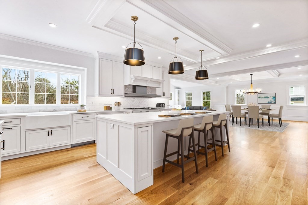 4 Jordan Way Hingham, MA 02043 - Photo 2 of 42 a kitchen with stainless steel appliances kitchen island granite countertop a stove a sink a dining table and chairs with wooden floor