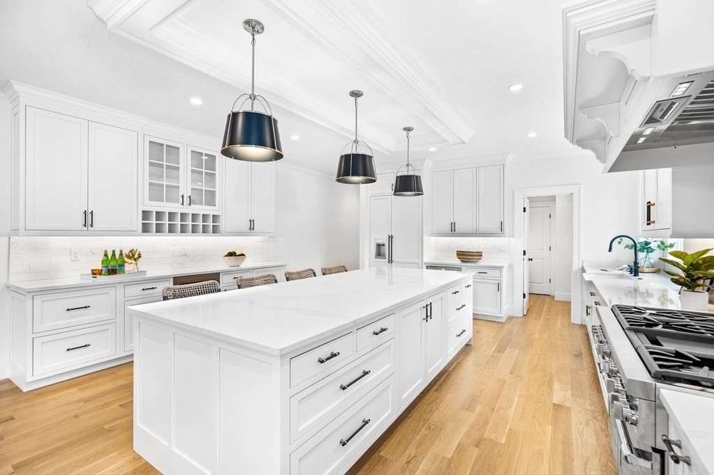 4 Jordan Way Hingham, MA 02043 - Photo 5 of 42 a large kitchen with stainless steel appliances a stove a sink dishwasher and white cabinets with wooden floor