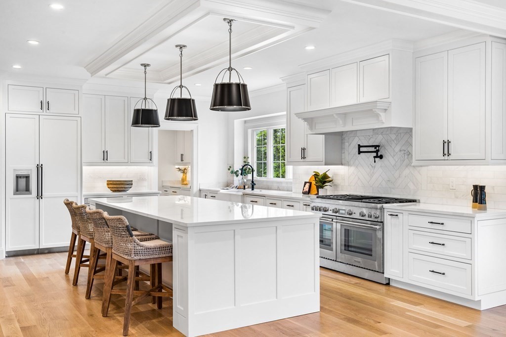 4 Jordan Way Hingham, MA 02043 - Photo 8 of 42 a kitchen with stainless steel appliances kitchen island granite countertop a table chairs sink and cabinets