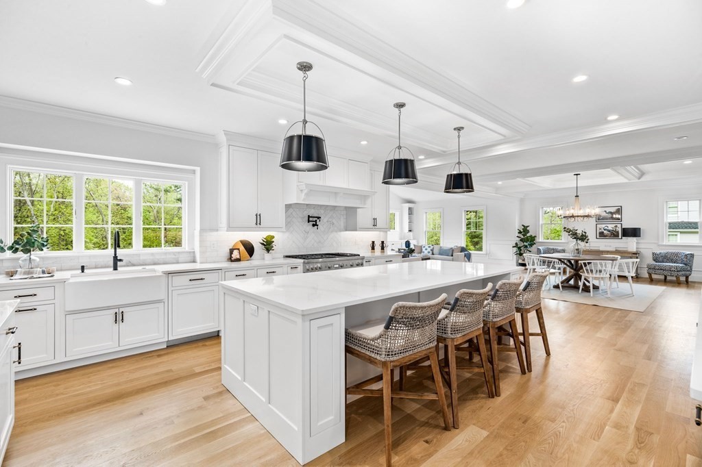 4 Jordan Way Hingham, MA 02043 - Photo 10 of 42 a kitchen with stainless steel appliances kitchen island granite countertop a table chairs sink and cabinets