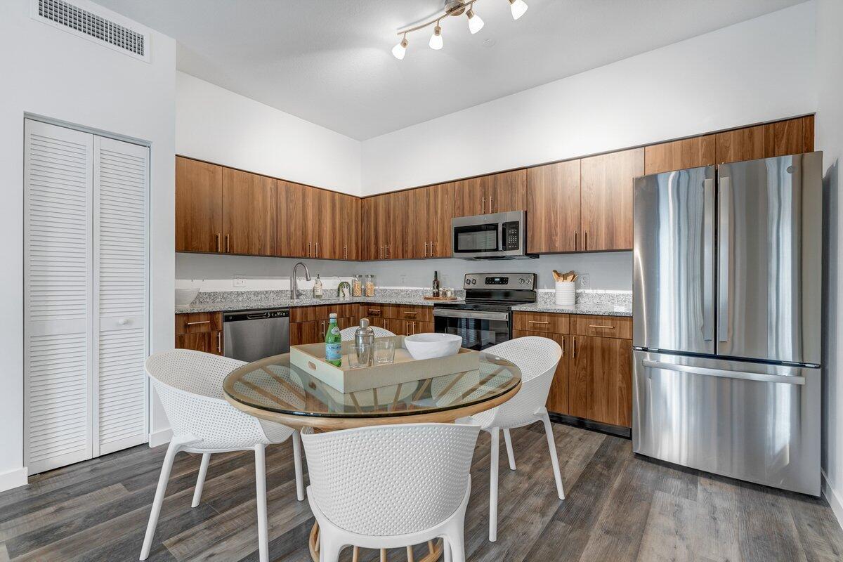 a kitchen with a dining table and chairs
