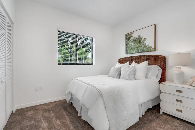 a bedroom with a bed and a night stand