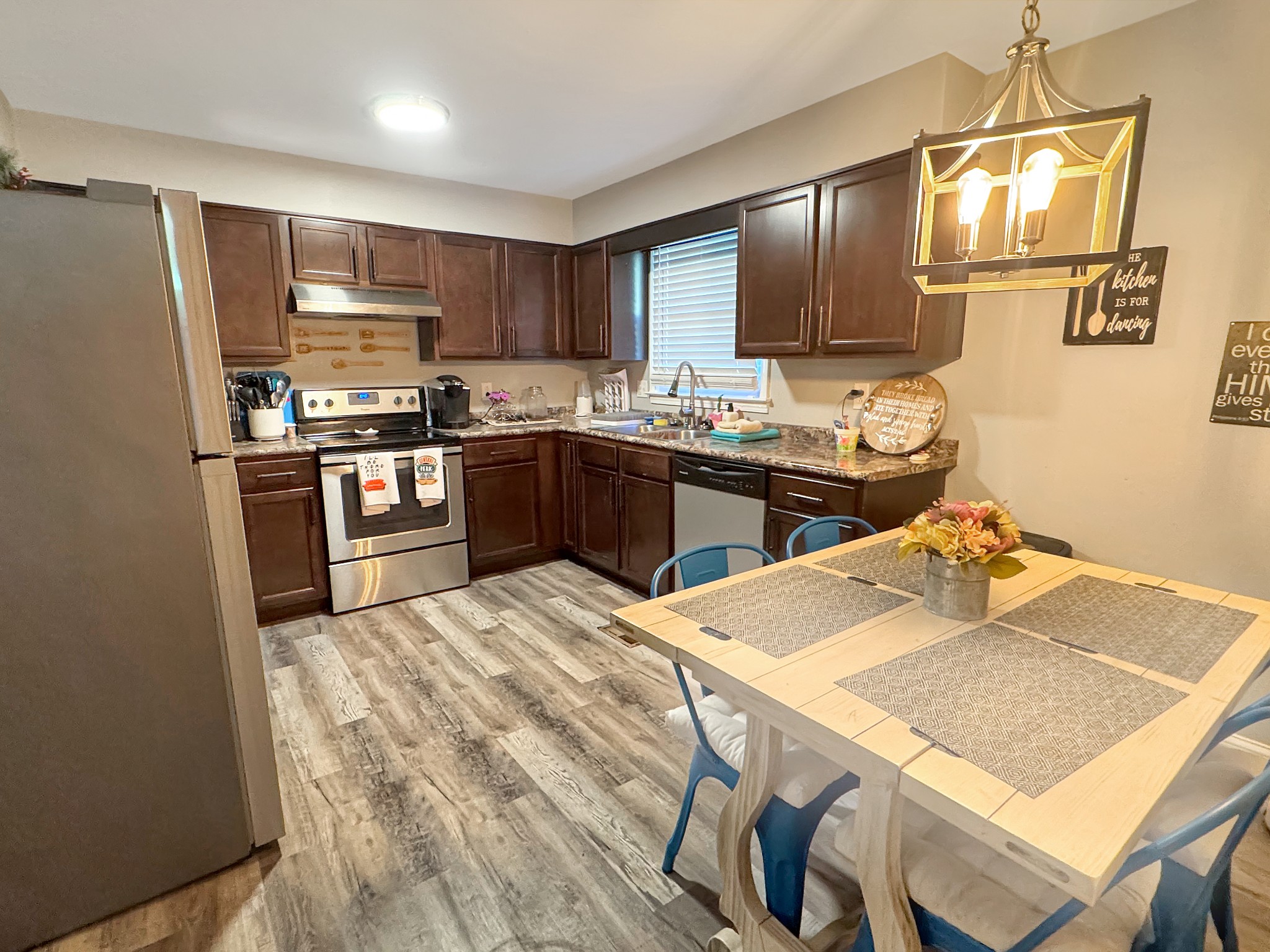 333 Main Street Dover, TN 37058 - Photo 8 of 19 a kitchen with stainless steel appliances kitchen island granite countertop a sink dishwasher a stove a refrigerator with a dining table and chairs
