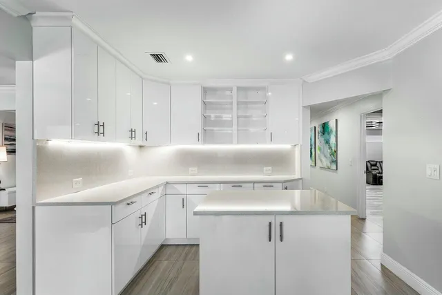 a kitchen with counter top space sink and living room