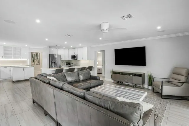 a bedroom with a bed a dresser and night lamp