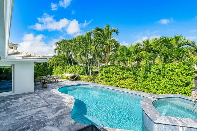 a front view of house with a garden and patio