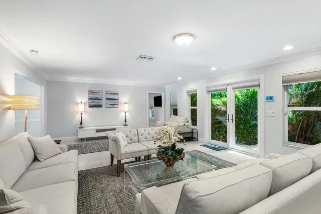a living room with furniture and a large window