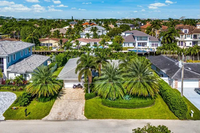 an aerial view of a house with garden space and a patio