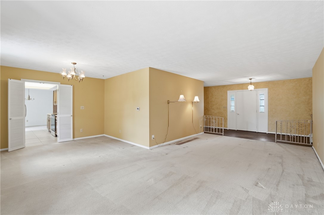 9964 Hummingbird Way Dayton, OH 45458 - Photo 11 of 57 This expansive living area offers versatile design possibilities with direct access to the kitchen.