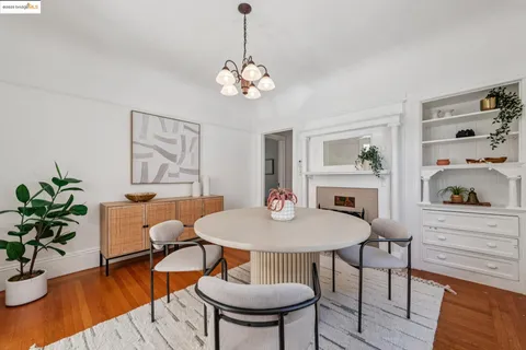 a view of a dining room with furniture wooden floor and chandelier